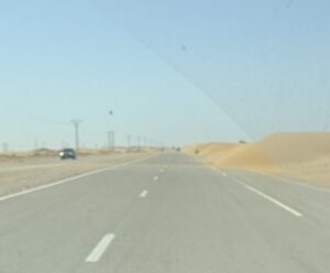 A photo of a road with sand dunes on it in Laayoune, Western Sahara taken by Spiro Stakauskas
