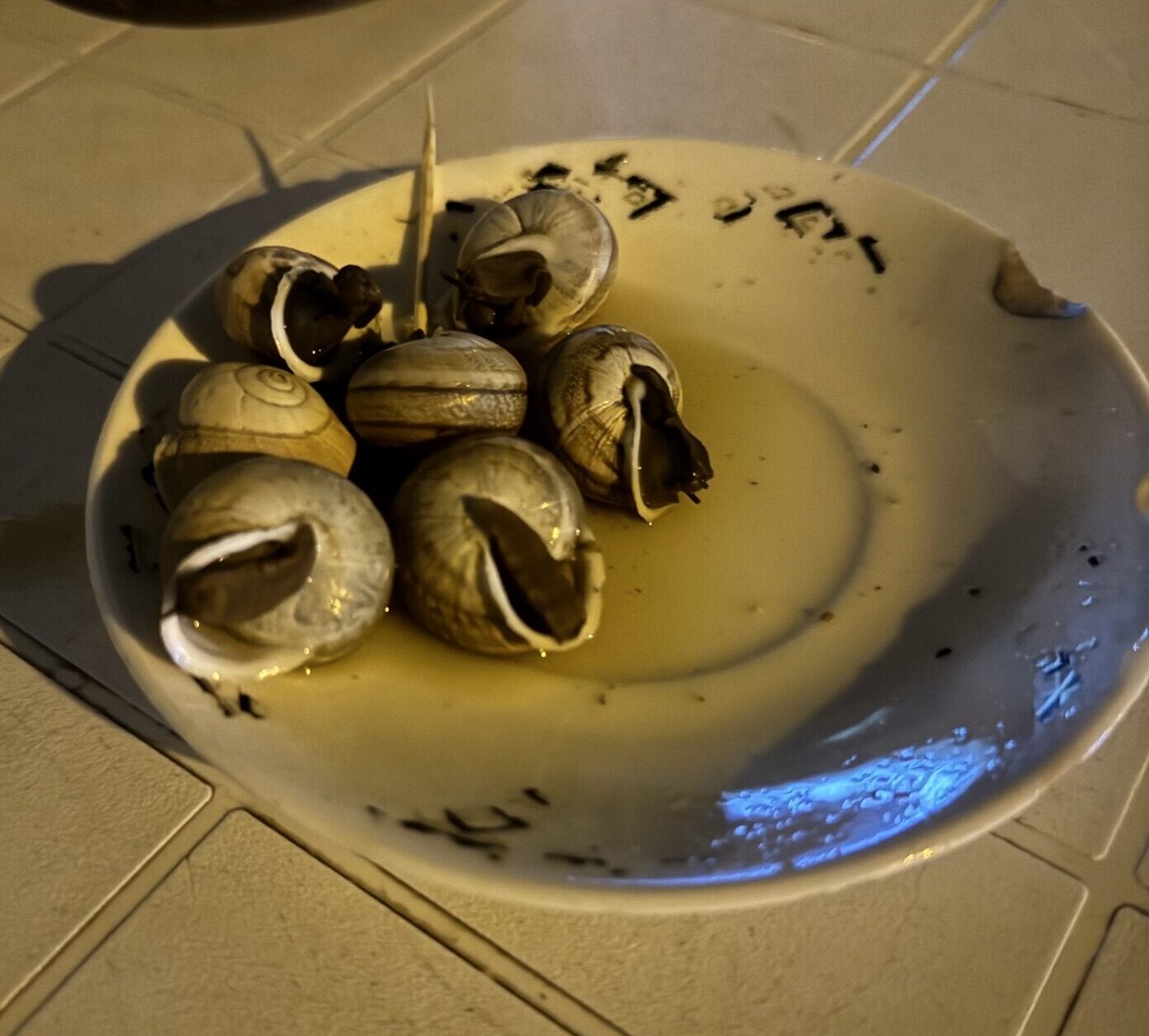 A photo of a plate with cooked snails on it taken by Spiro Stakauskas